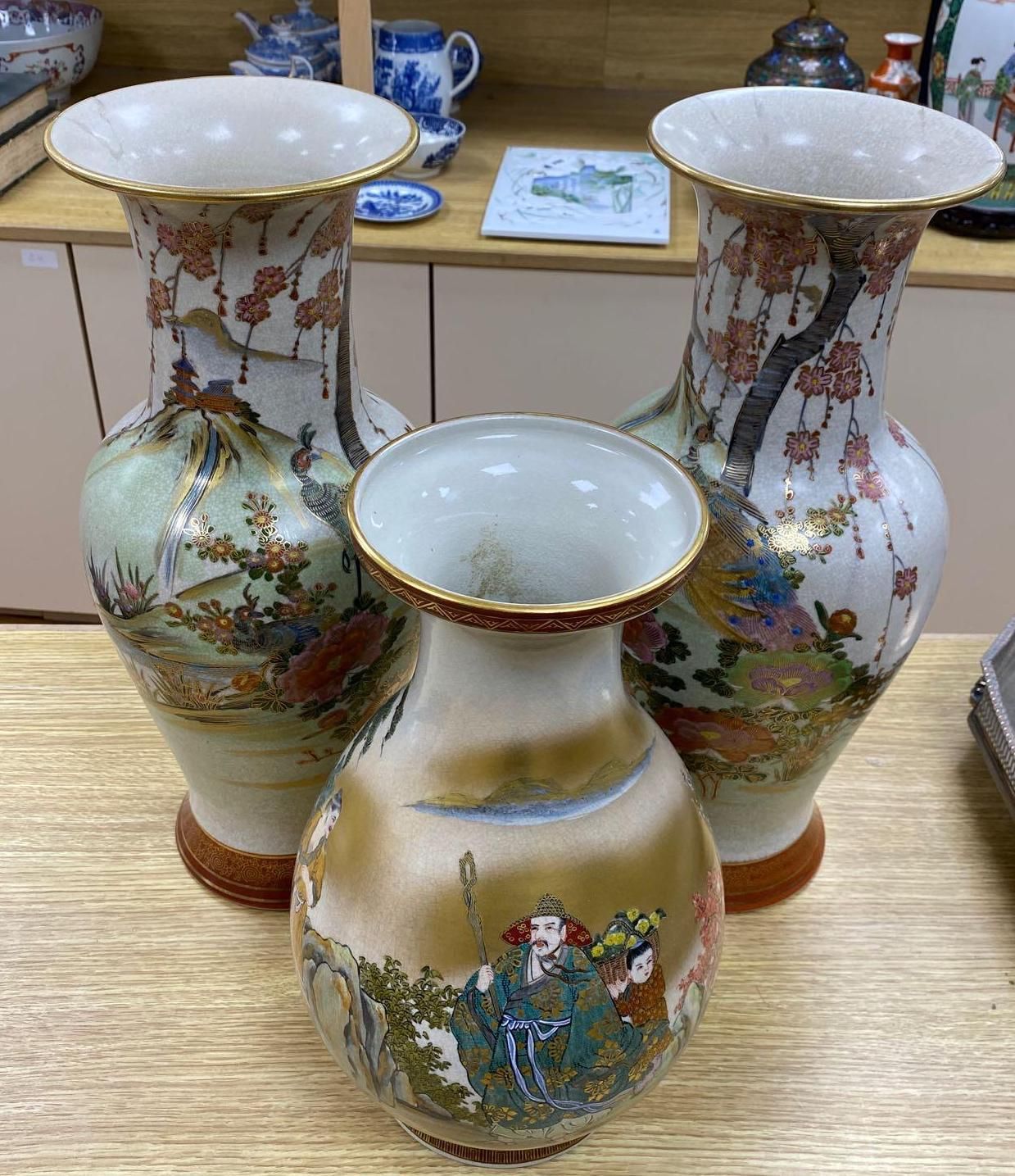 A pair of Japanese satsuma baluster vases, height 46cm, and a satsuma bulbous vase, height 37cm